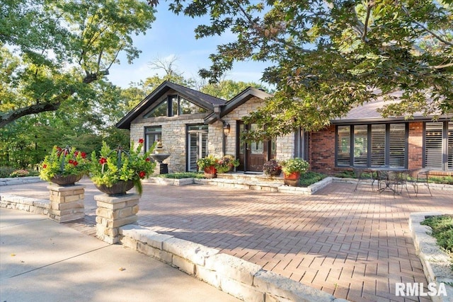 view of front of property featuring stone siding and brick siding