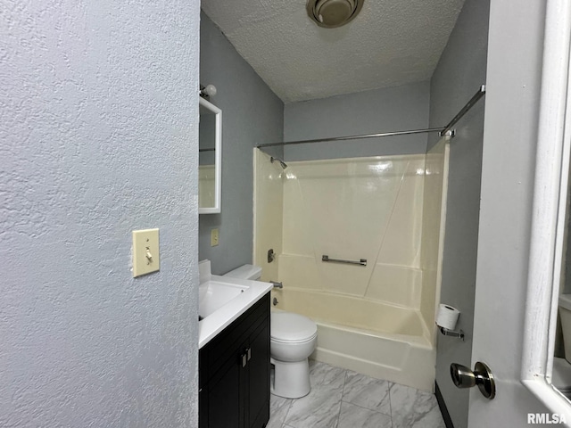 full bath featuring a textured ceiling, toilet, vanity, marble finish floor, and shower / bathing tub combination