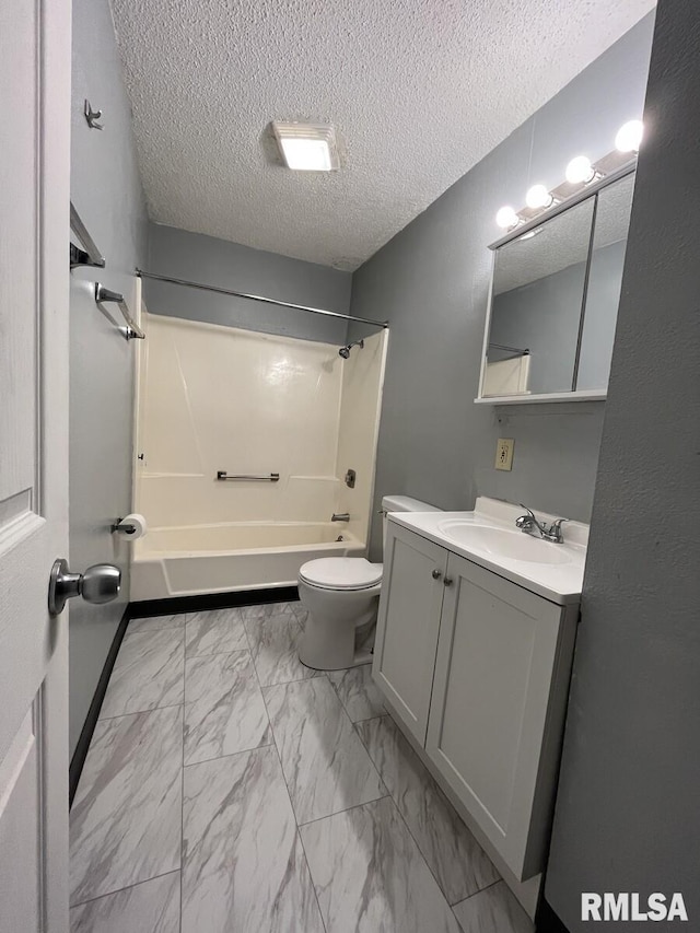 full bath featuring a textured ceiling, toilet, bathing tub / shower combination, vanity, and marble finish floor