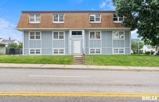 629 W Washington St, Springfield, IL 62702 - view of front of house with a shingled roof, board and batten siding, mansard roof, and a front lawn