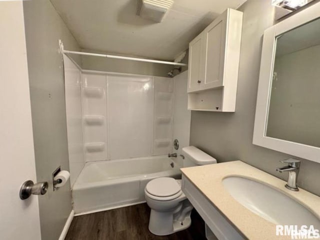 bathroom with bathing tub / shower combination, visible vents, toilet, a sink, and wood finished floors