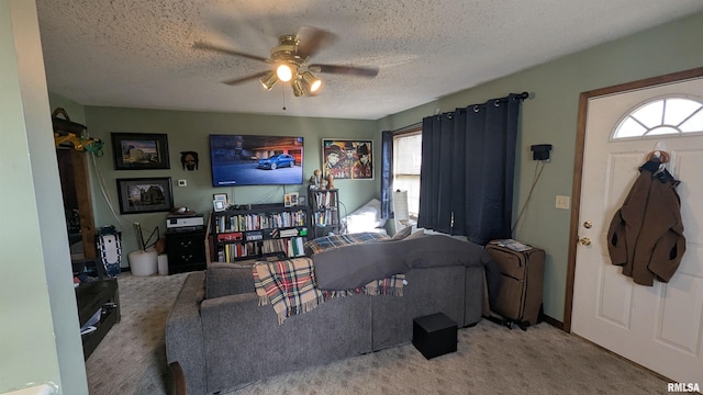 living area with ceiling fan, a textured ceiling, and a wealth of natural light