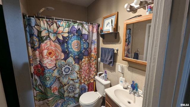 bathroom with toilet, a shower with shower curtain, tile walls, and vanity