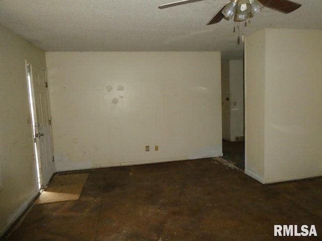 empty room featuring ceiling fan and a textured ceiling