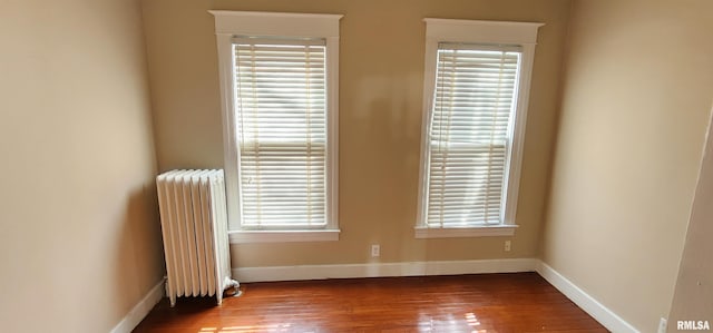 814 W Edwards St, Springfield, IL 62704 - unfurnished room featuring radiator heating unit, hardwood / wood-style flooring, baseboards, and healthy amount of natural light