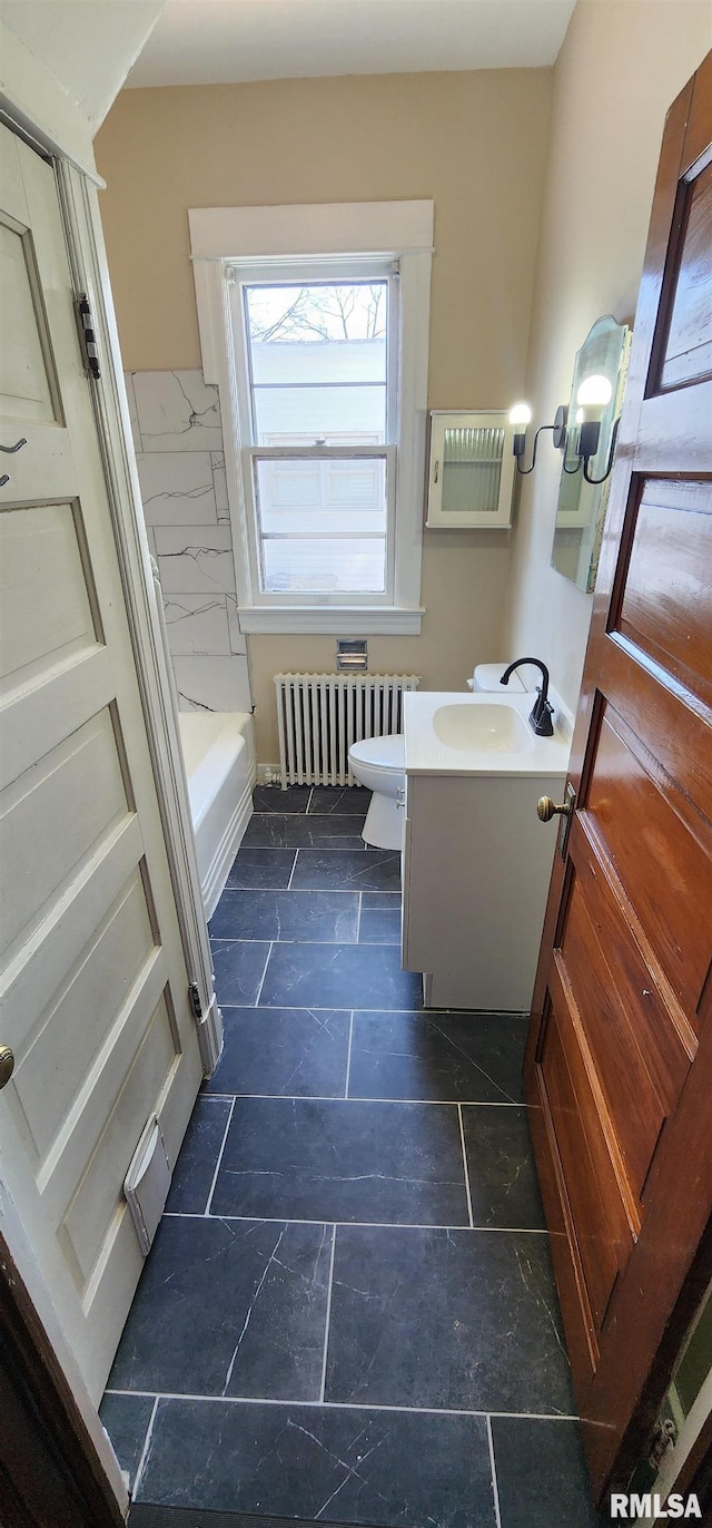 814 W Edwards St, Springfield, IL 62704 - full bathroom with radiator, vanity, a bathtub, and toilet