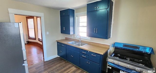 814 W Edwards St, Springfield, IL 62704 - kitchen featuring a sink, freestanding refrigerator, and blue cabinets