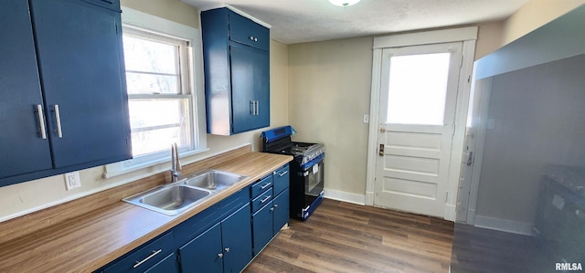 814 W Edwards St, Springfield, IL 62704 - kitchen with gas range, blue cabinetry, a sink, dark wood-style flooring, and a textured ceiling