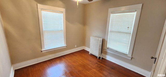 814 W Edwards St, Springfield, IL 62704 - empty room with radiator heating unit, baseboards, dark wood finished floors, and ceiling fan