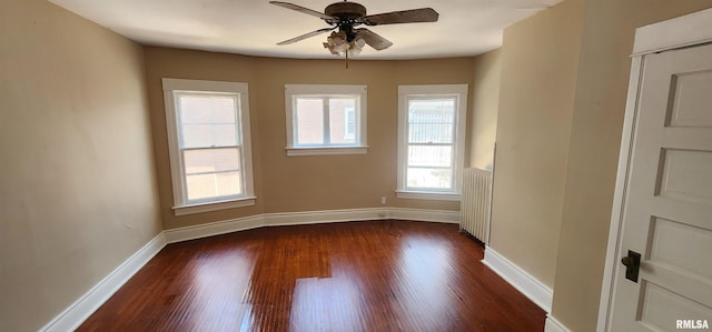 814 W Edwards St, Springfield, IL 62704 - unfurnished room with radiator, dark wood-type flooring, ceiling fan, and baseboards