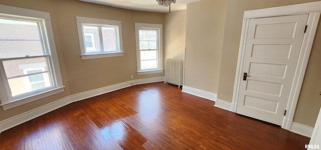 814 W Edwards St, Springfield, IL 62704 - unfurnished room featuring radiator, plenty of natural light, dark wood-type flooring, and baseboards