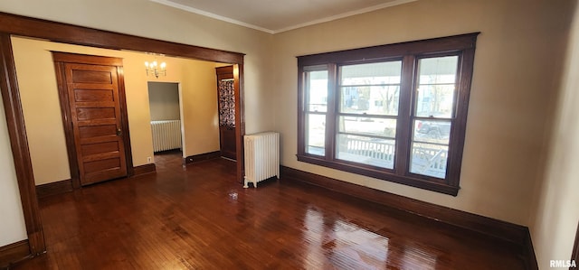 814 W Edwards St, Springfield, IL 62704 - unfurnished room with radiator, a chandelier, baseboards, dark wood finished floors, and crown molding