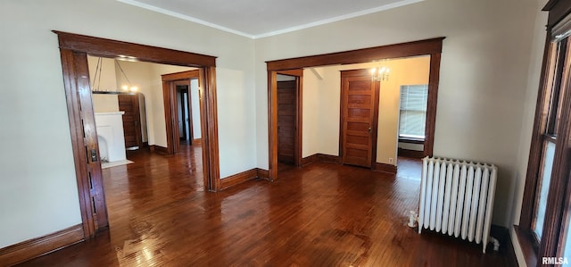 814 W Edwards St, Springfield, IL 62704 - corridor featuring radiator, a chandelier, baseboards, ornamental molding, and wood finished floors