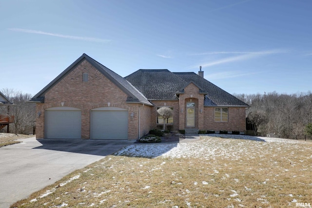 view of front of property featuring an attached garage, brick siding, concrete driveway, roof with shingles, and a chimney