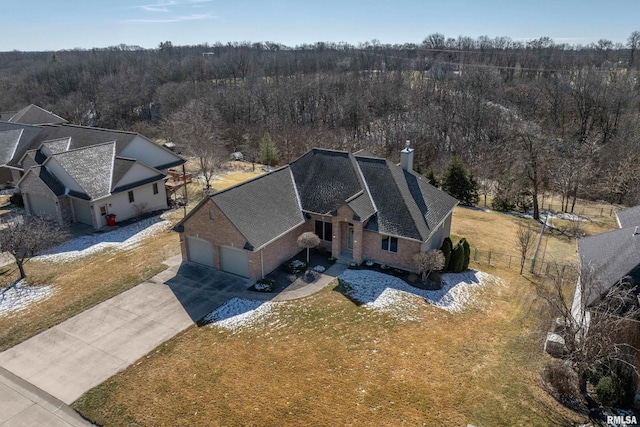 birds eye view of property with a forest view