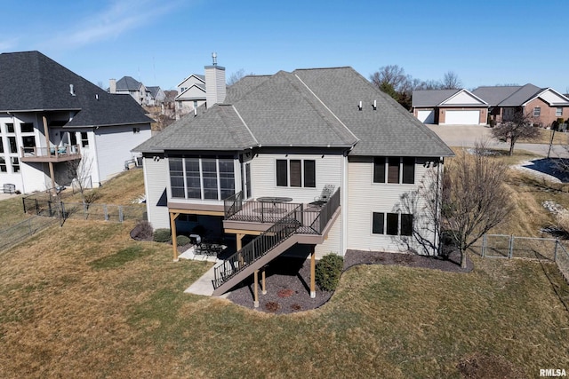 back of property with a lawn, stairway, a fenced backyard, and a sunroom