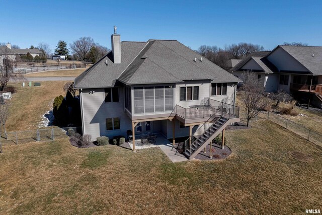 rear view of property with a sunroom, stairs, a patio, and a yard