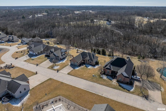 drone / aerial view featuring a residential view and a view of trees