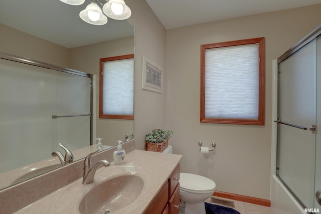 bathroom featuring toilet, vanity, visible vents, and baseboards