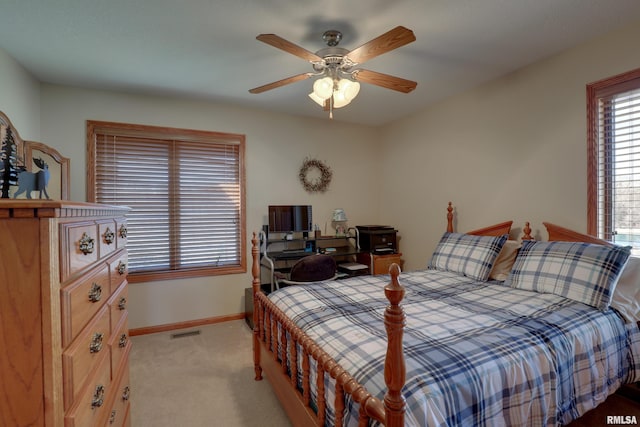 bedroom with baseboards, ceiling fan, visible vents, and light colored carpet