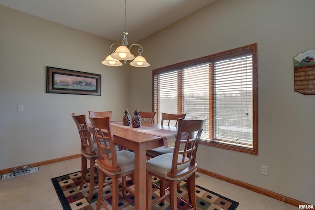 dining room with a chandelier, baseboards, and light tile patterned floors