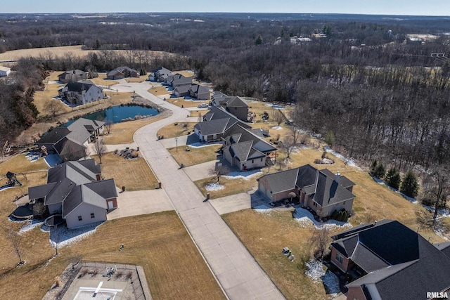 drone / aerial view featuring a wooded view