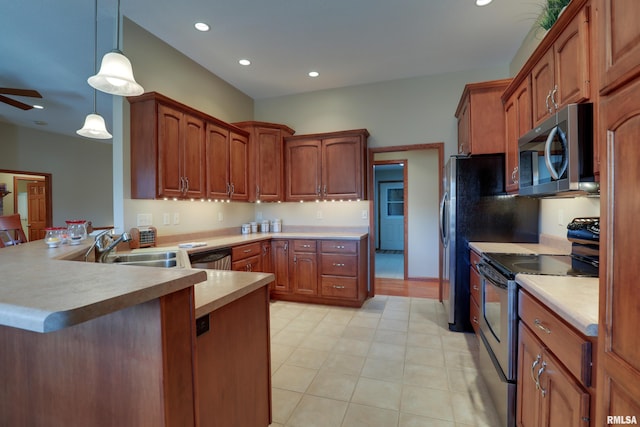 kitchen featuring ceiling fan, a peninsula, light countertops, appliances with stainless steel finishes, and pendant lighting