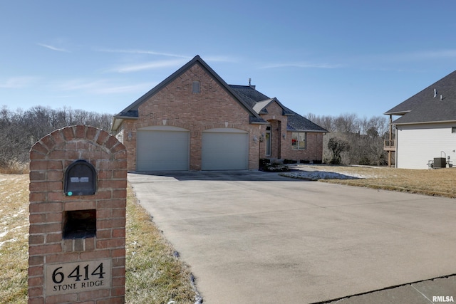 view of front facade with concrete driveway, brick siding, and an attached garage