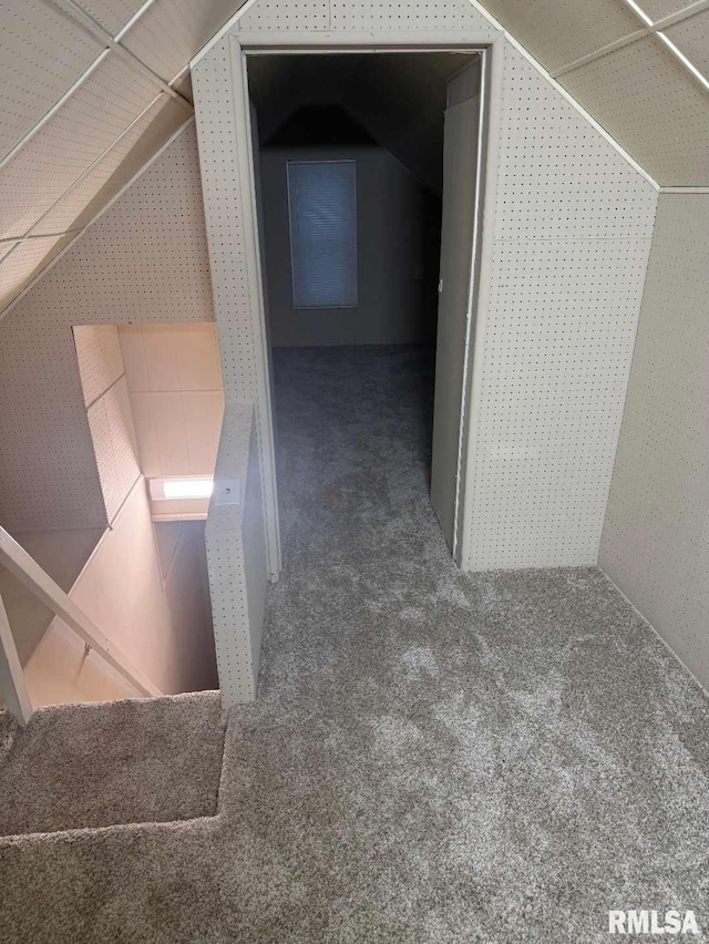 interior space featuring lofted ceiling and carpet floors