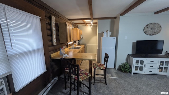 dining area featuring beam ceiling