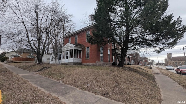 view of home's exterior with a residential view and brick siding