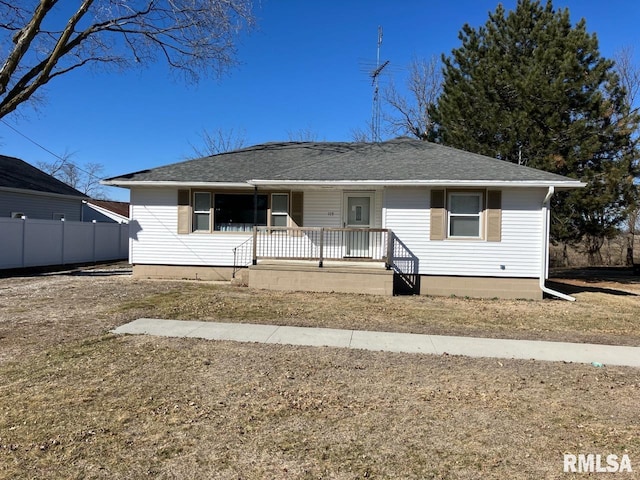 view of front of property featuring covered porch, roof with shingles, and fence