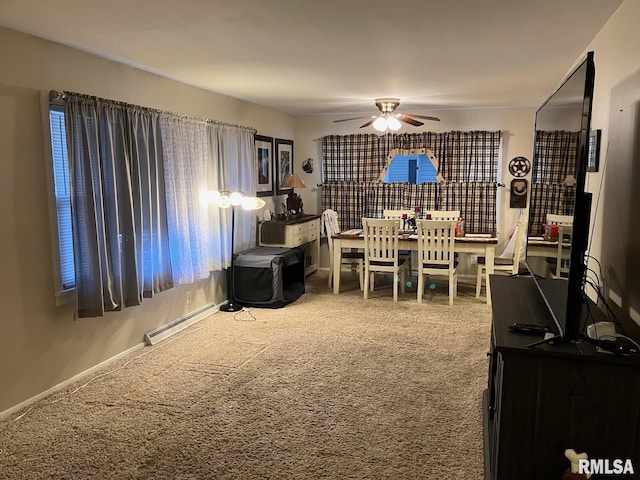 carpeted dining room featuring a baseboard radiator, baseboards, and ceiling fan