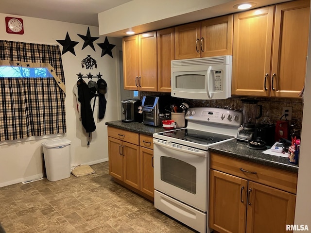 kitchen with dark countertops, white appliances, tasteful backsplash, and baseboards