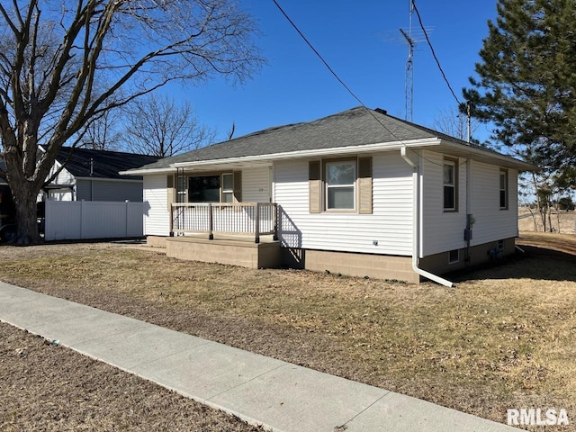 view of front of property with fence, a porch, and roof with shingles