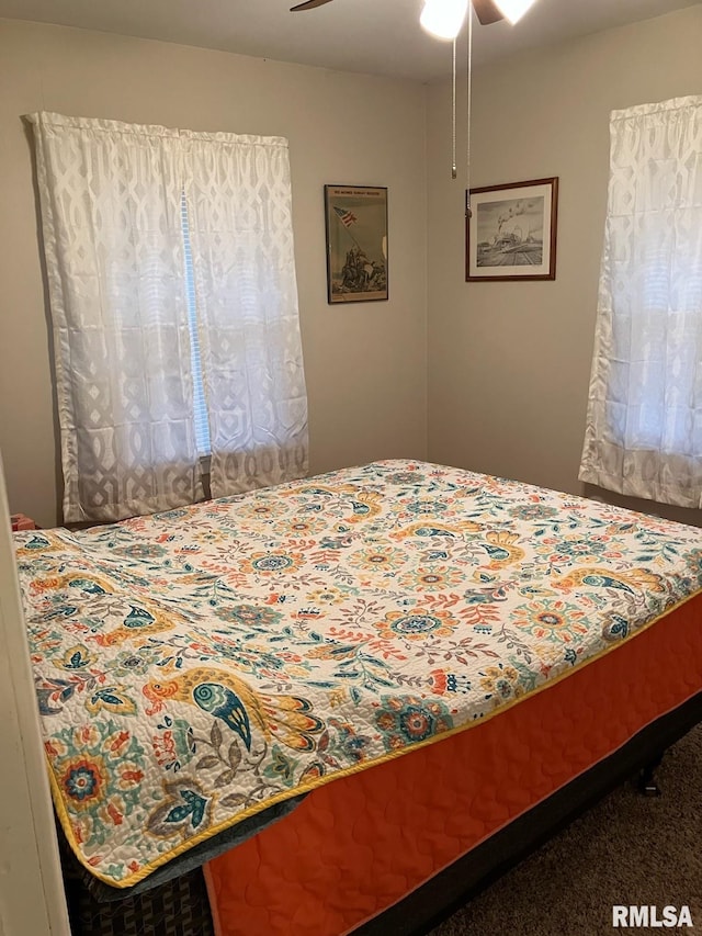 carpeted bedroom with ceiling fan