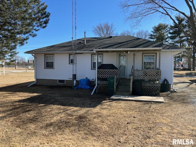 back of property with covered porch