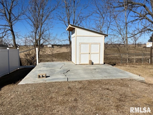 view of shed featuring fence