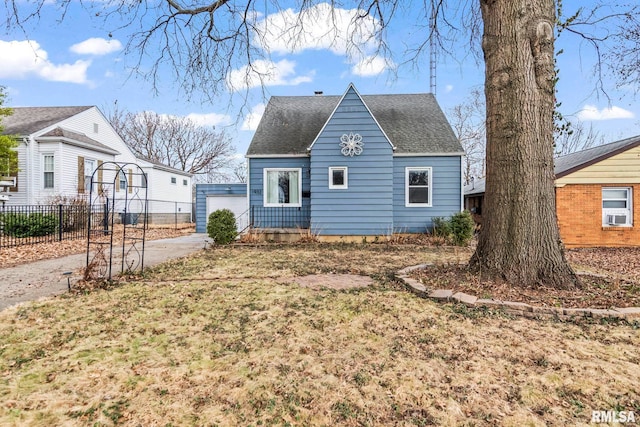 view of front of home featuring a shingled roof, cooling unit, and fence