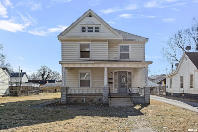 american foursquare style home with a porch and fence