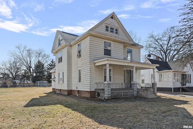 traditional style home with covered porch and a front lawn