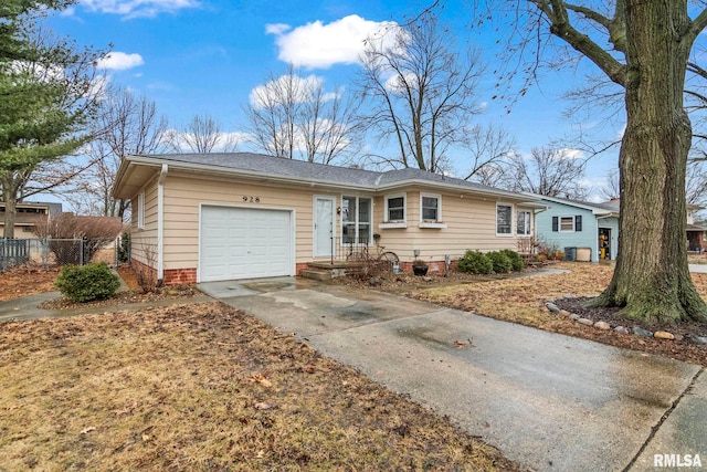 ranch-style house with a garage, driveway, and fence