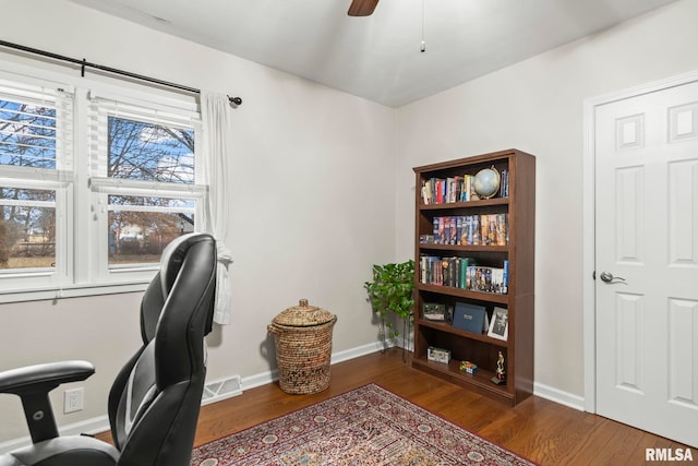 office area with a ceiling fan, wood finished floors, visible vents, and baseboards