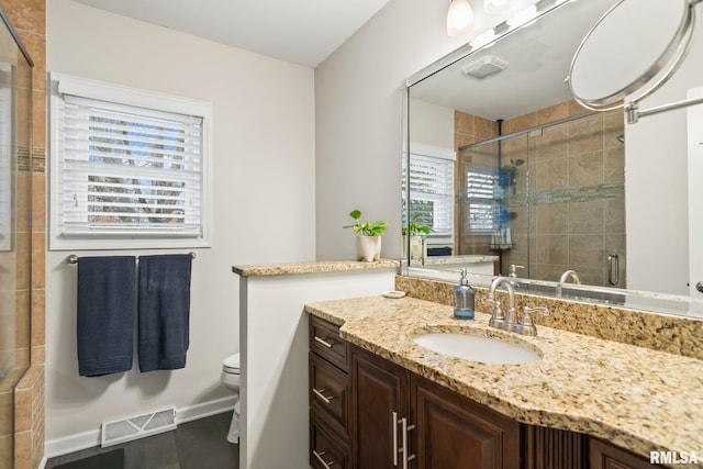 full bathroom with visible vents, baseboards, toilet, vanity, and a shower stall