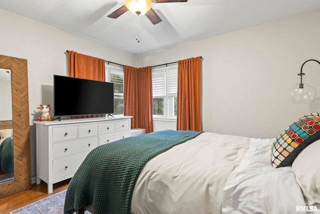 bedroom with ceiling fan and wood finished floors