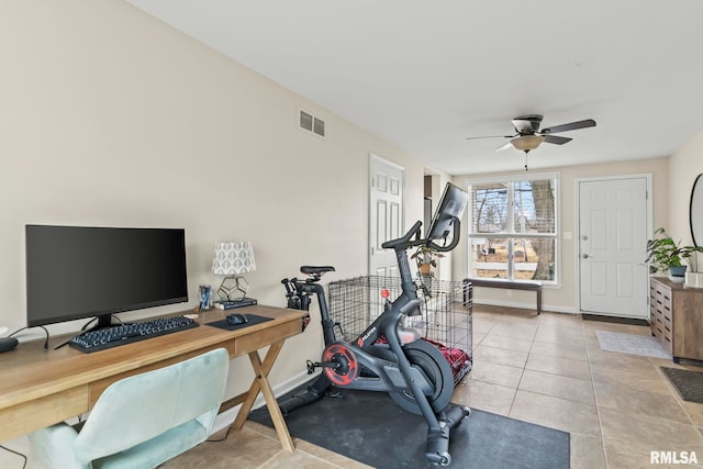 workout area featuring baseboards, tile patterned flooring, visible vents, and a ceiling fan