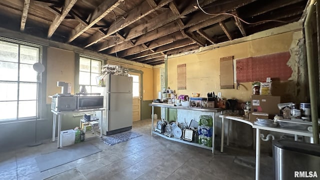 kitchen featuring freestanding refrigerator and stainless steel microwave