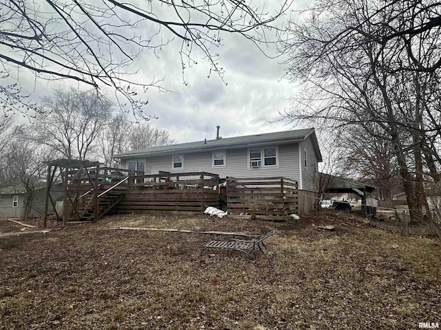 rear view of house with stairs and a wooden deck