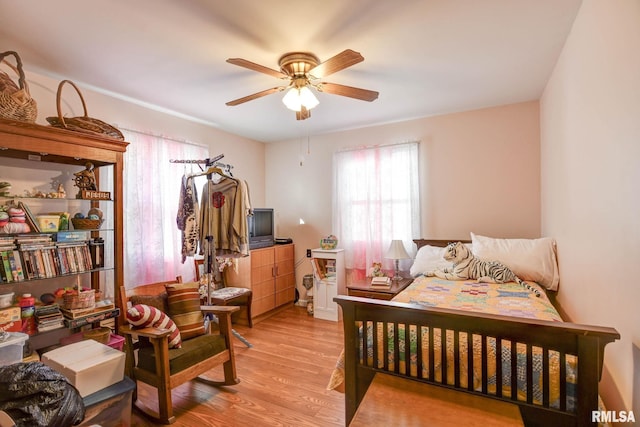 bedroom with ceiling fan and wood finished floors