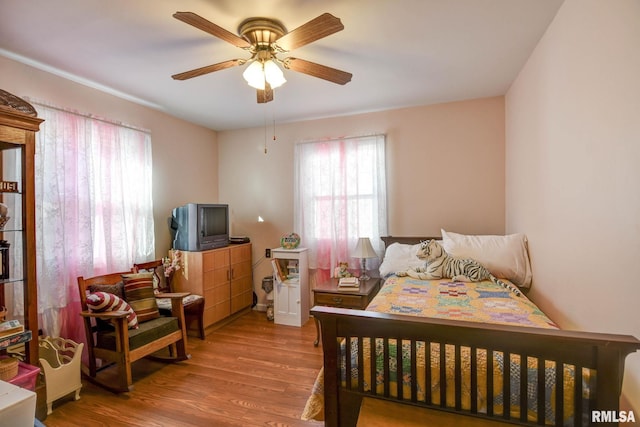 bedroom featuring a ceiling fan and wood finished floors